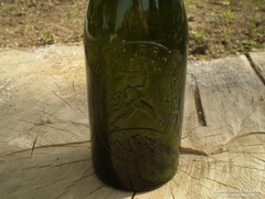 Old beer bottle in glass