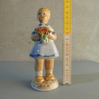 Glazed ceramic figurine of a little girl with a bouquet of flowers