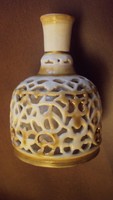 Zsolnay is a small decorative vase with a double wall, pierced in the outer mantle, with a (honeycomb) lacy mesh surface.