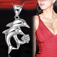 Silver plated double dolphin pendant with white crystals