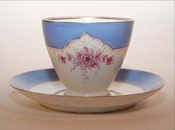 Porcelain teacup with painted decoration and saucer
