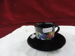 French porcelain coffee cup + placemat. Floral pattern on a black background. He has!