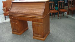 Natural pine wood desk with blinds.
