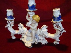 Crown regal fine porcelain three-prong candle holder with putto. He has!