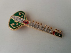 Brooch pin embellished with gold-plated fire enamel and small white polished stones