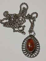 An old necklace, perhaps with an amber pendant.