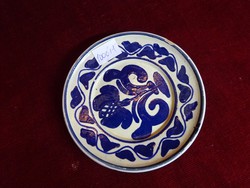 Hand-painted glazed ceramic wall ornament with folk motif, diameter 12.5 cm. He has!