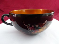 Hand-painted tea cup with dragon motifs. He has!