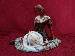 Porcelain figural sculpture, hand painting, of a lady sitting on the grass with a hat in her hand. He has!