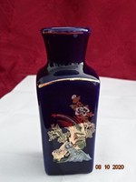 Japanese porcelain vase, on a cobalt blue background with a gold/green motif. He has!
