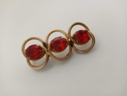 Old filigree brooch set with large red stones