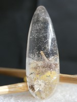 Natural rock crystal with actinolite and chlorite needle inclusions.