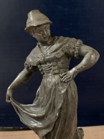 Nepviseletet viselő lányt ábrázoló szobrocska