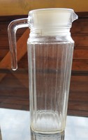 Old ribbed glass jug with plastic stopper