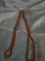 A long string of golden brown pearls
