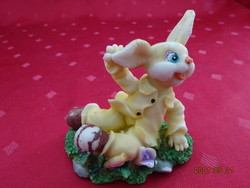 Yellow dressed Easter bunny in the grass, length 8 cm. He has!