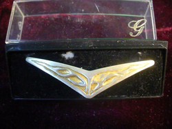 In a silver-plated badge box