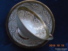 Large golden flower patterned tea cup with coaster and decorative tongs