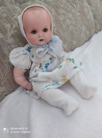 Antique sleeping doll in original clothes.