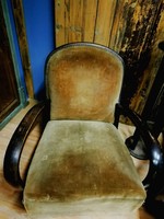 Art deco curved hardwood armchair with plush upholstery