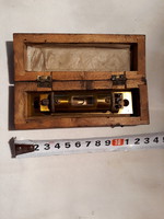 Old copper spirit level in wooden box