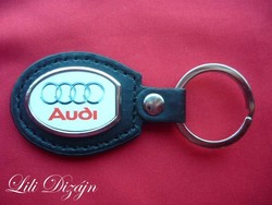 Audi oval metal keychain on a leather background