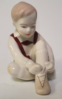Aquincum porcelain figurine, statue of a little boy tying his shoes