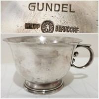 Metal cup marked 