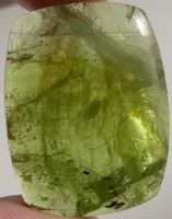 A gemstone overgrown with natural peridot mineral polished with stunning ludwigite inclusions. 34.8 Ct