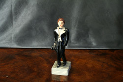 Male boy in tuxedo with tailcoat with a 15cm painted plaster figure in a tailcoat with a cylinder