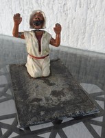 Antique enameled dervish sculpture on a prayer rug with a moving head - ornament