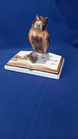 Owl sitting on a ceramic book in Bodrogkeresztúr with the inscription and image of Budapest