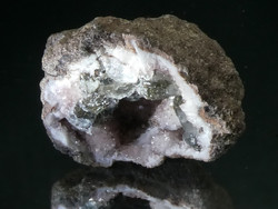 Natural pink quartz and gray calcite crystals in the geode. Fluorescent mineral specialty