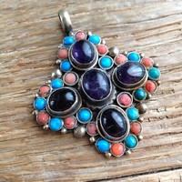 Craft pendant decorated with amethyst, coral and turquoise stones