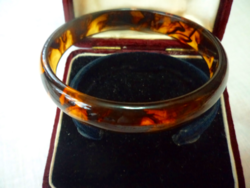 Flawless, cast bracelet with an amber effect