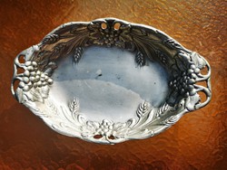 Silvered bowl with bunch of grapes