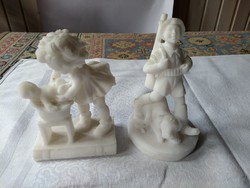 A cheerful hunter boy and a little girl bathing their baby carved out of salt