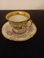 Porcelain cup with a baroque design and richly decorated gilded edges.