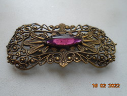 Antique filigree brooch with purple claw stone