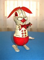 Old, pull-up, enamel-painted metal bunny with a key