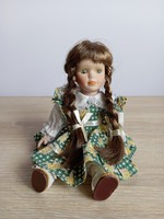 Porcelain doll in plaid dress
