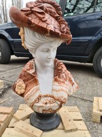 Lady in a hat with a marble bust