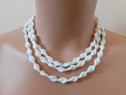 Old long porcelain necklace with twisted eyes