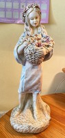 About a forint - little girl holding a basket with a plaster sculpture