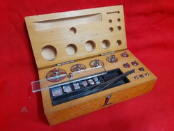 Old precision laboratory weighing set in wooden box.