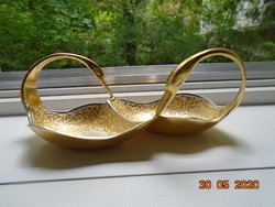 A new, handmade centerpiece with a pair of gilded plastic swans, detailed relief patterns.