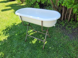 Old vintage enameled lampart in baby bath with enamel bathtub for kids tub with bathtub stand