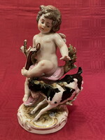Antique winged angel (cupid) with goat