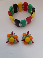 An ear clip made of glass and porcelain beads in a beautiful retro color scheme with a matching rubber bracelet