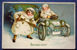 Antique gold-pressed New Year's greeting card with children pumping the wheel of an automobile
